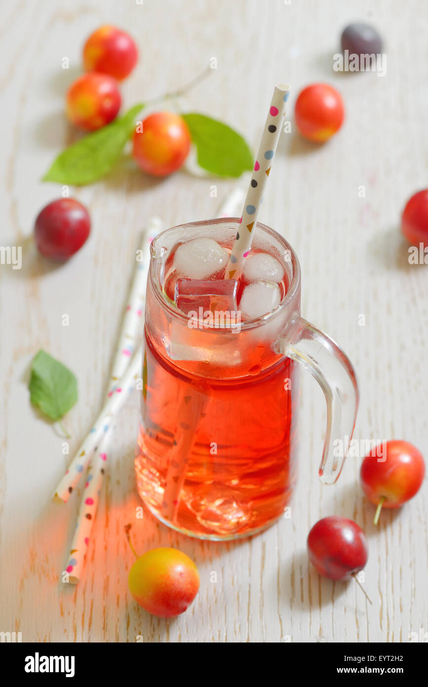 Plum compote and fresh plums with ice cubes Stock Photo