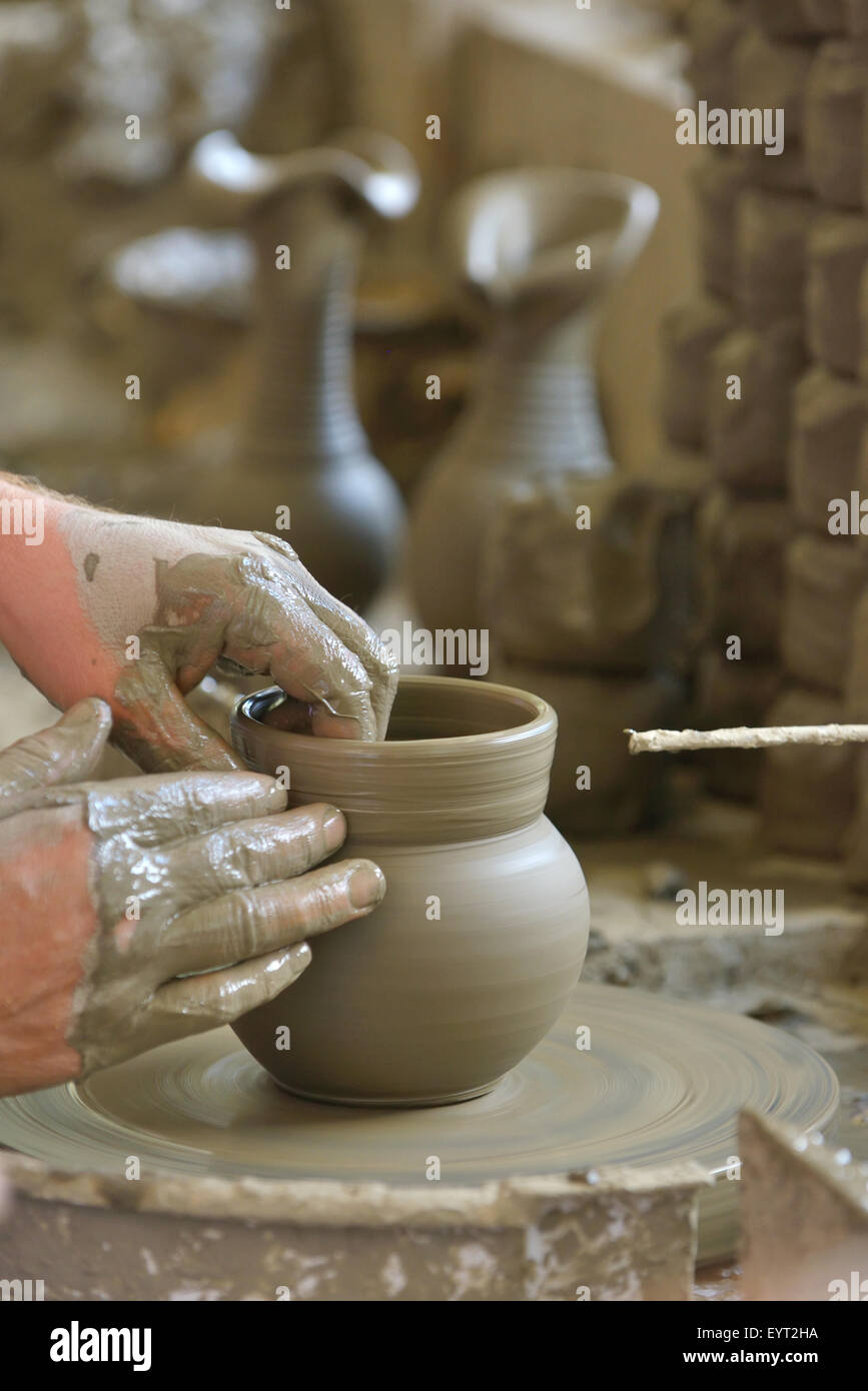 Artisan hands making clay pot Stock Photo