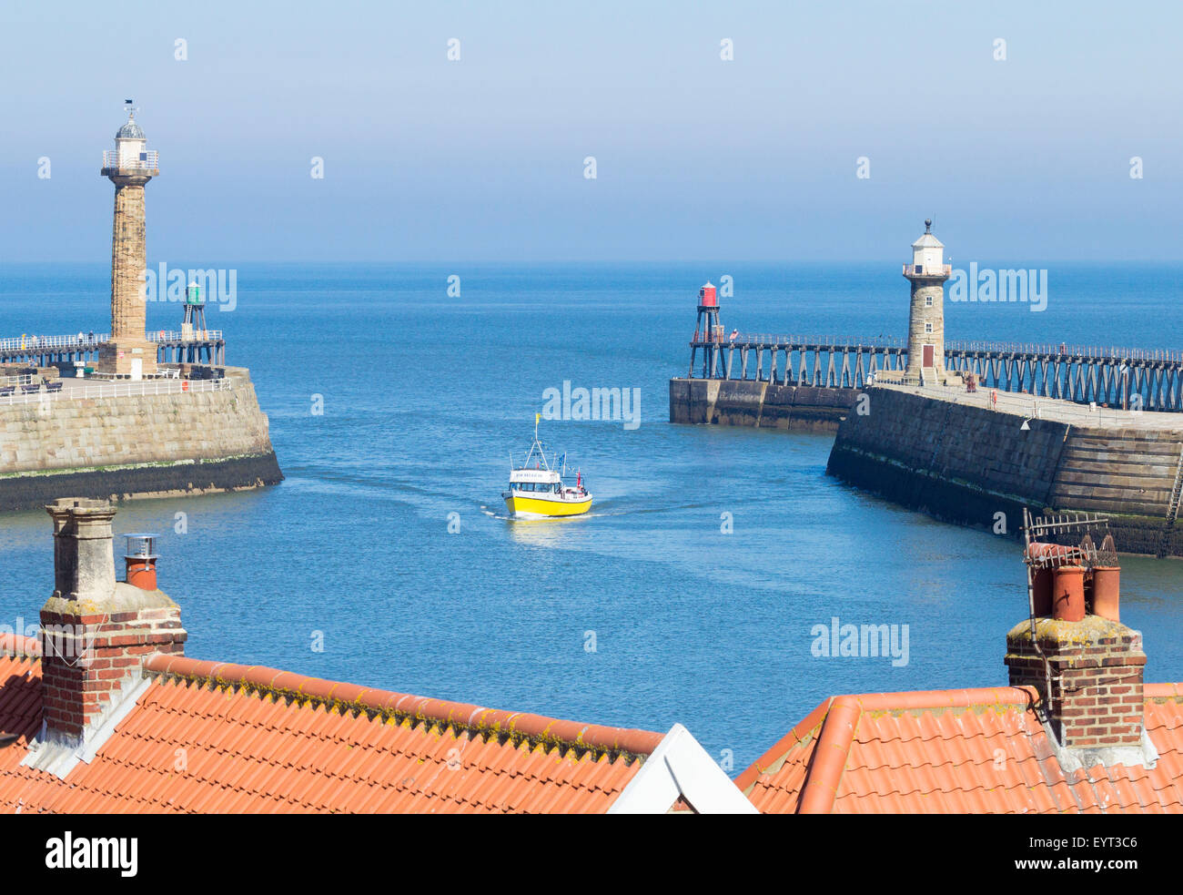 View of Whitby piers over rooftops. Whitby, North Yorkshire, England ...