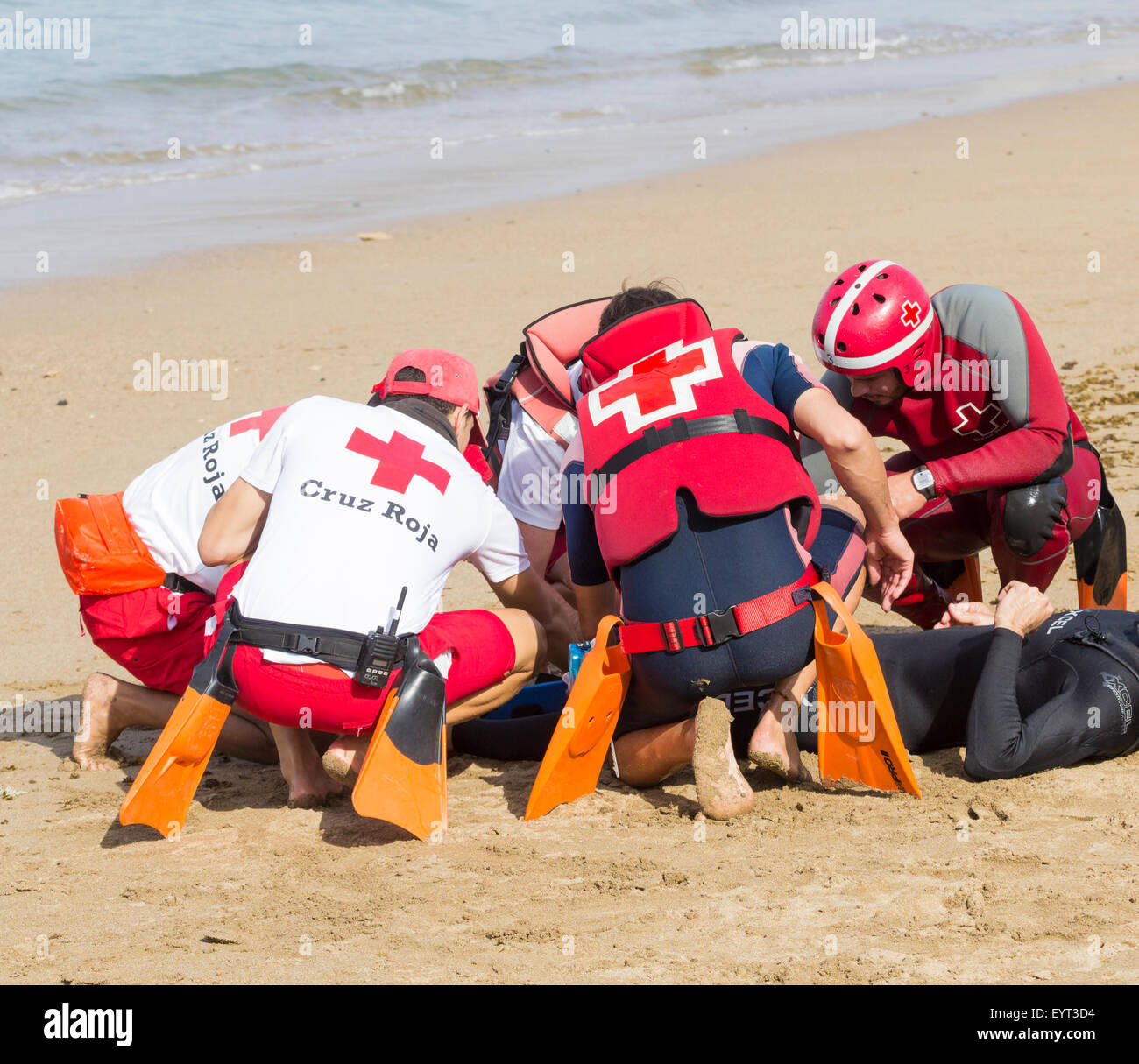 Red Cross Lifeguards and rescue services rescue simulation on beach in Spain Stock Photo