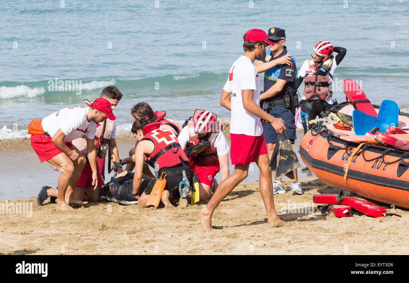 Red Cross Lifeguards and rescue services rescue simulation on beach in Spain Stock Photo