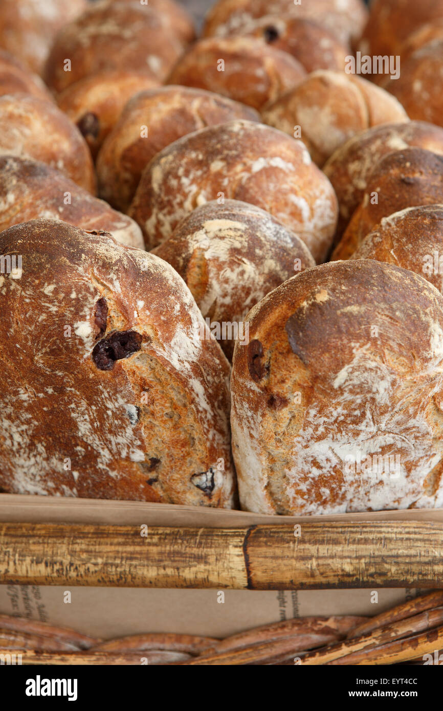 Close up view of loaves of freshly baked olive bread in basket Stock