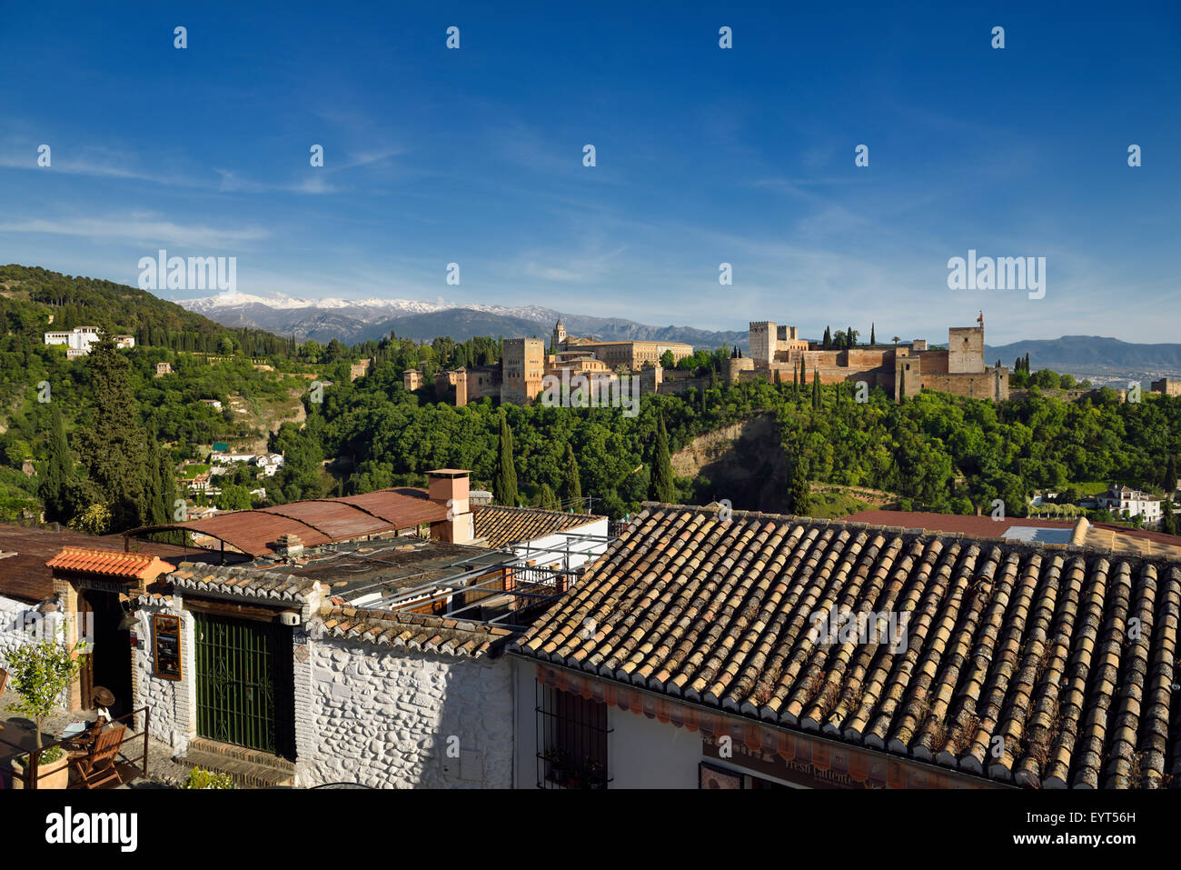 Albaicin restaurant at Saint Nicholas lookout with Generalife Alhambra fortress and Sierra Nevada Mountains Granada Stock Photo