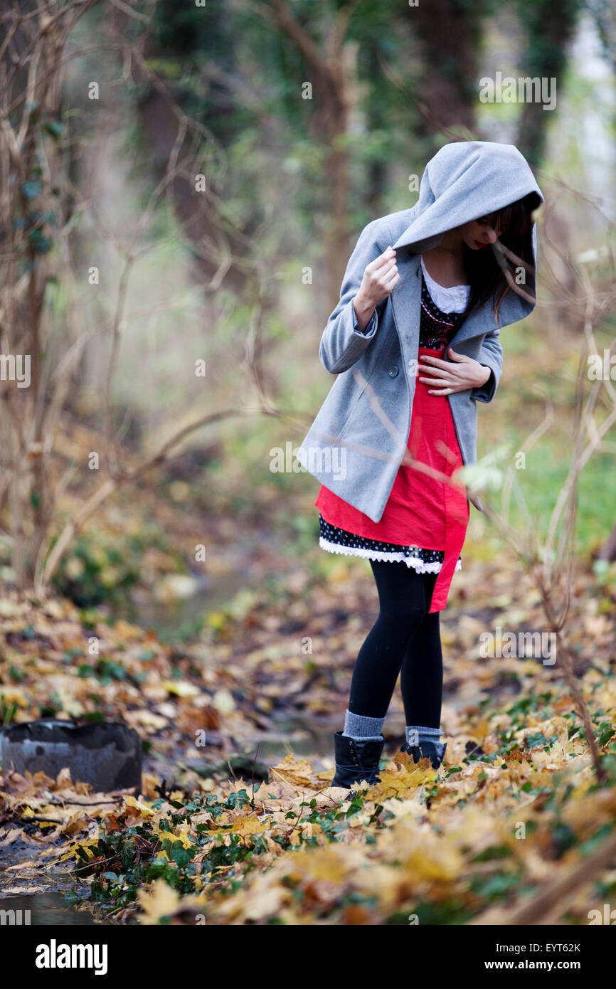Girl with hoodie jacket in the wood Stock Photo - Alamy