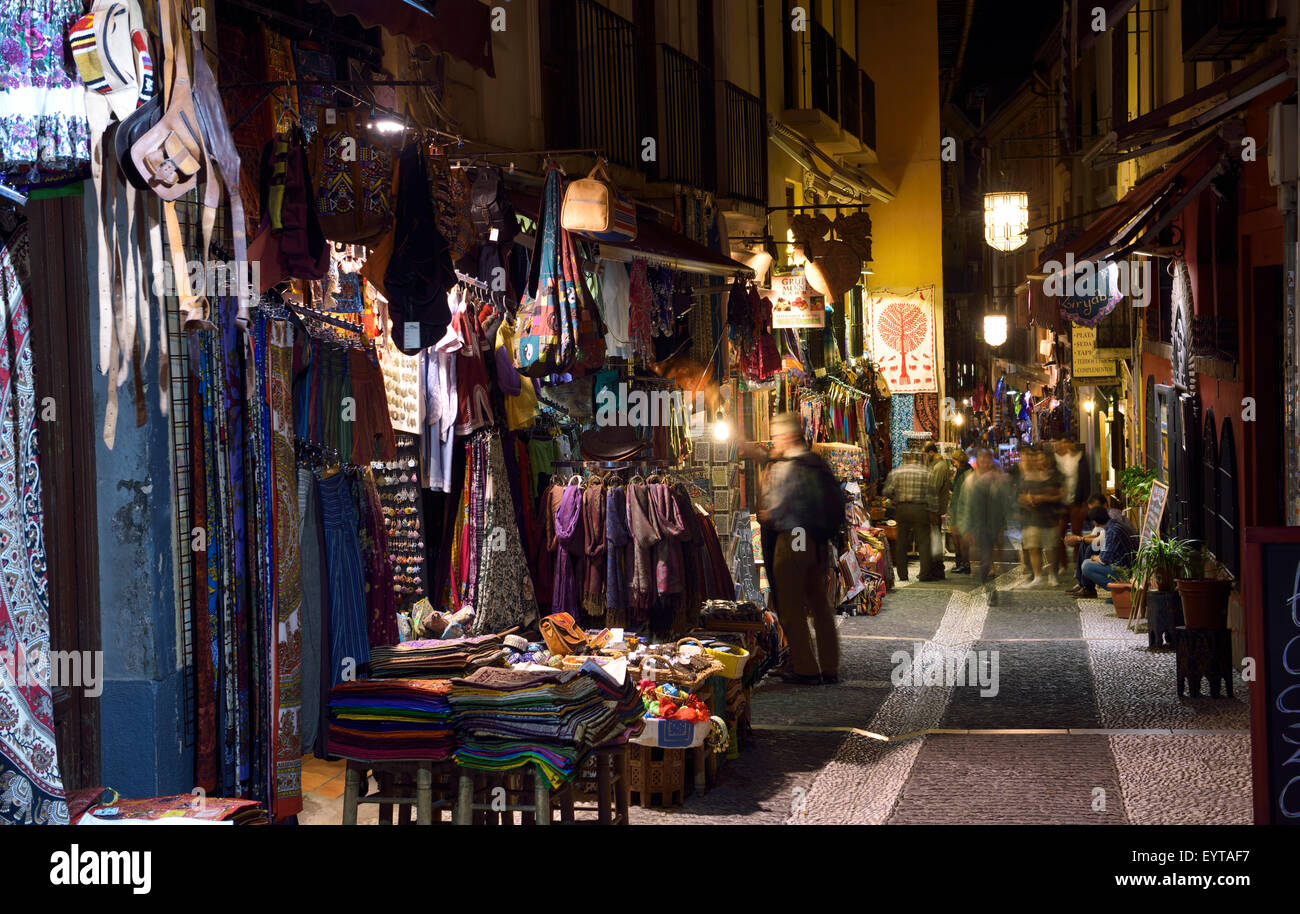 Shops and tourists at night on Caldereria Nueva pedestrian street Granada Stock Photo