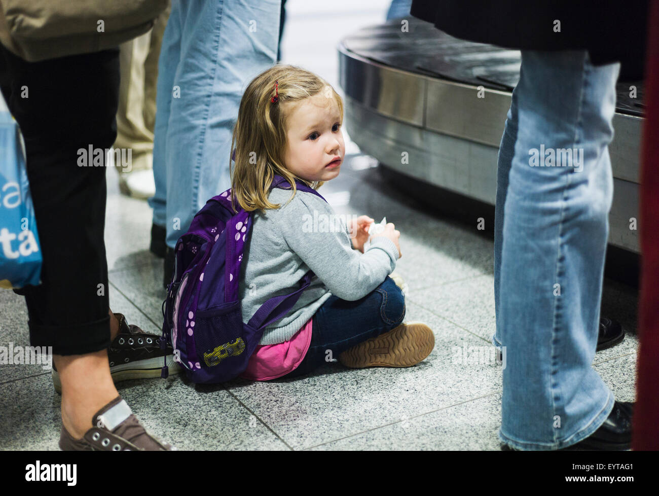 Girls, 3 years old, airport, baggage conveyor belt, floor, sitting, waiting, Stock Photo
