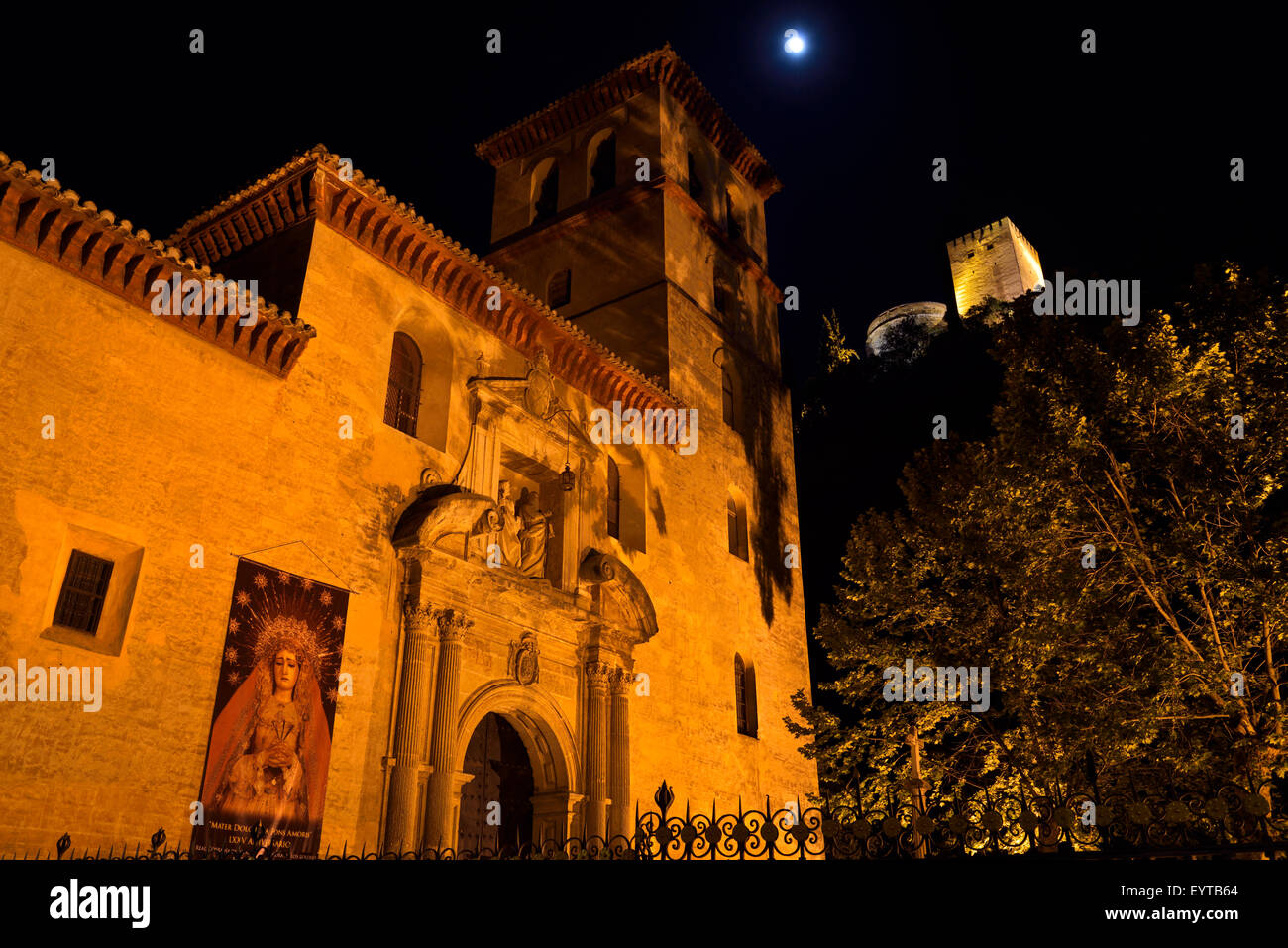 Church of Saint Peter and Paul at night with Alcazaba towers and moon in Granada Stock Photo