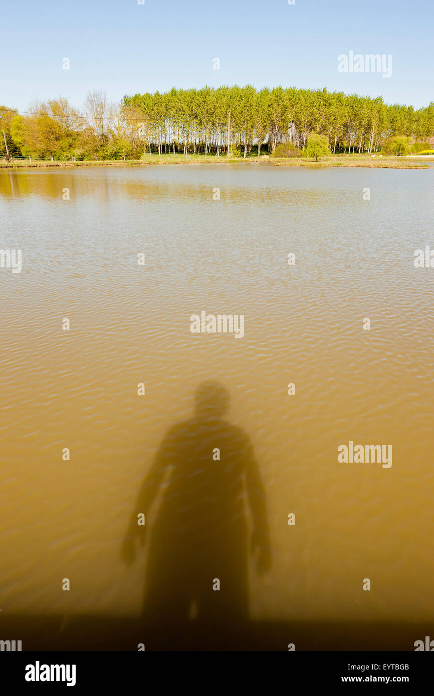 Shadow of a man in the lake Stock Photo