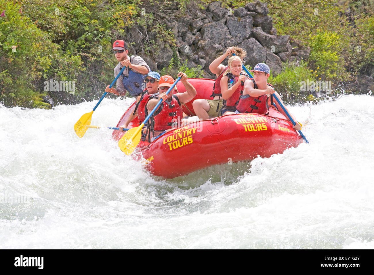 Whitewater rafters during the summer on Big Eddy Falls on the Deschutes River near Bend, Oregon Stock Photo