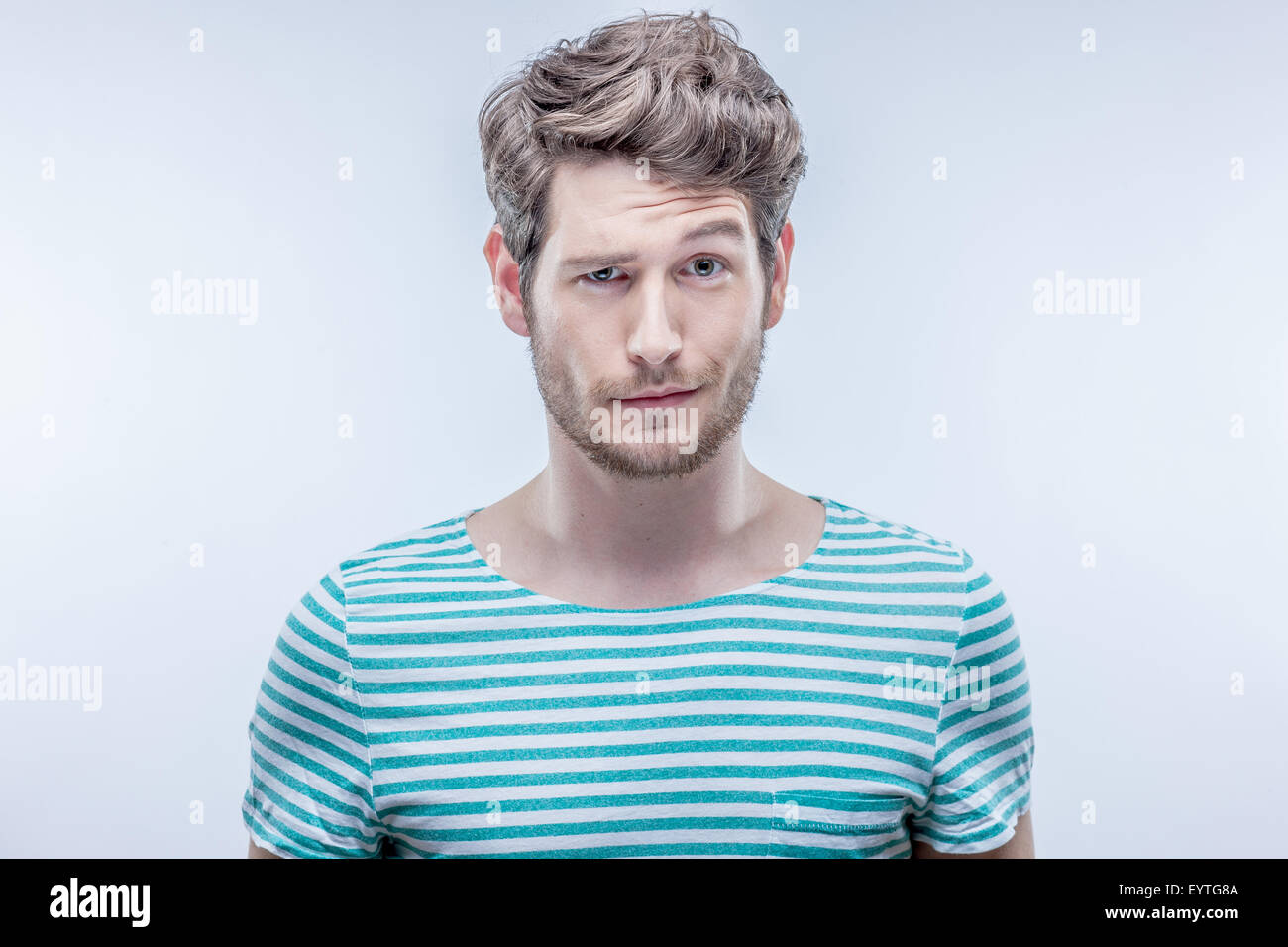 Young man looking doubtfully Stock Photo