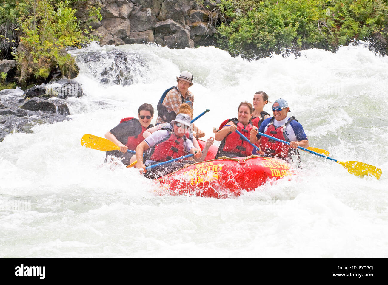 Whitewater rafters during the summer onBig Eddy Falls on the Deschutes River near Bend, Oregon Stock Photo