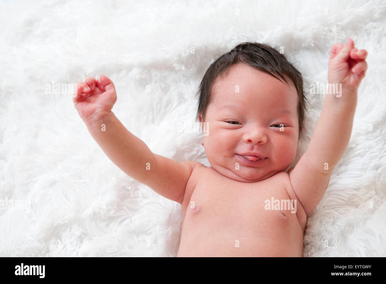 Happy newborn baby with arms up in the air Stock Photo Alamy