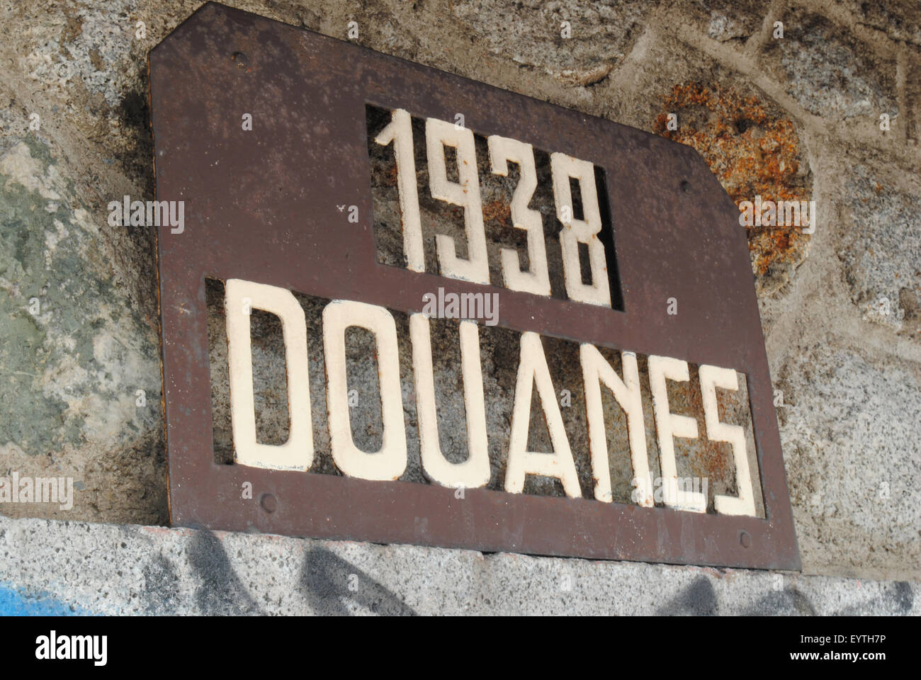 A 'Douanes' (customs) sign and the year 1938 on the façade of an abandoned customs house. Stock Photo