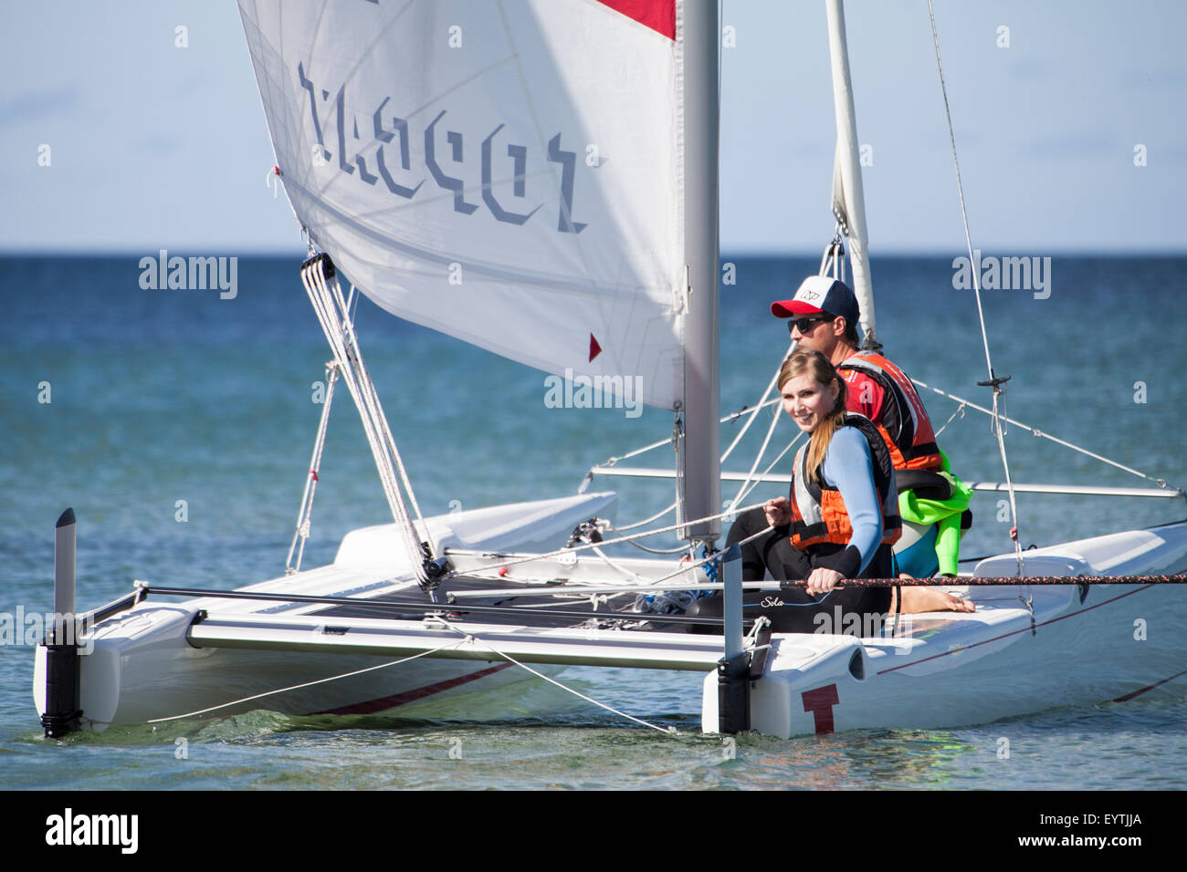 Sail lessons, schoolgirl sailing the catamaran Stock Photo Alamy