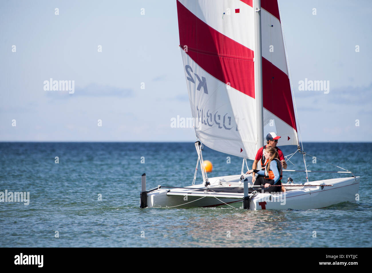Sail lessons on the catamaran, schoolgirl get the sail close Stock