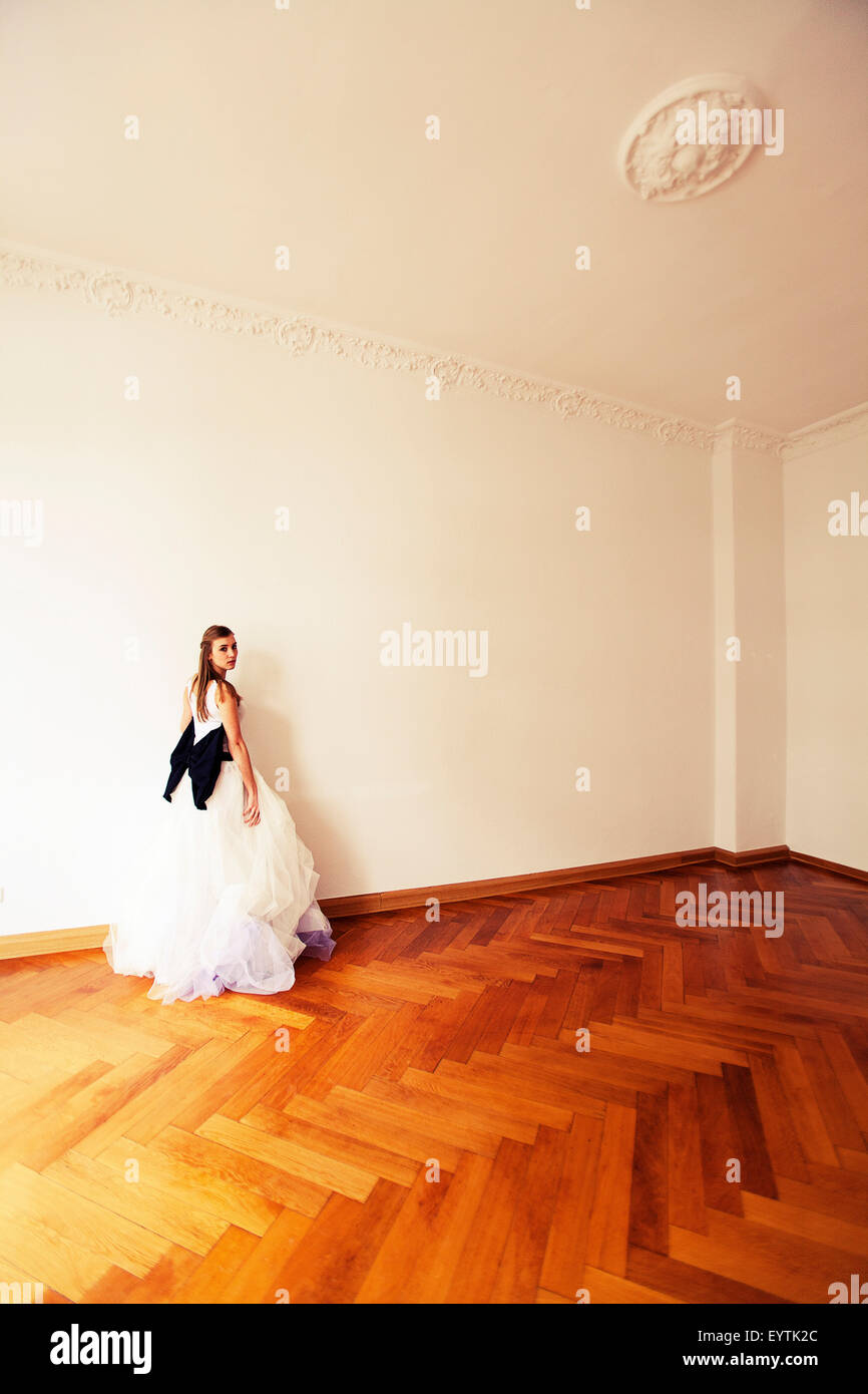 Bride standing in an old apartment, looking at camera Stock Photo