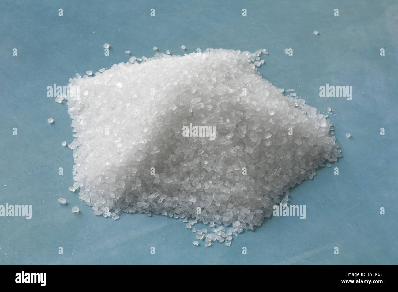 Coarse sea salt on light blue ground Stock Photo Alamy