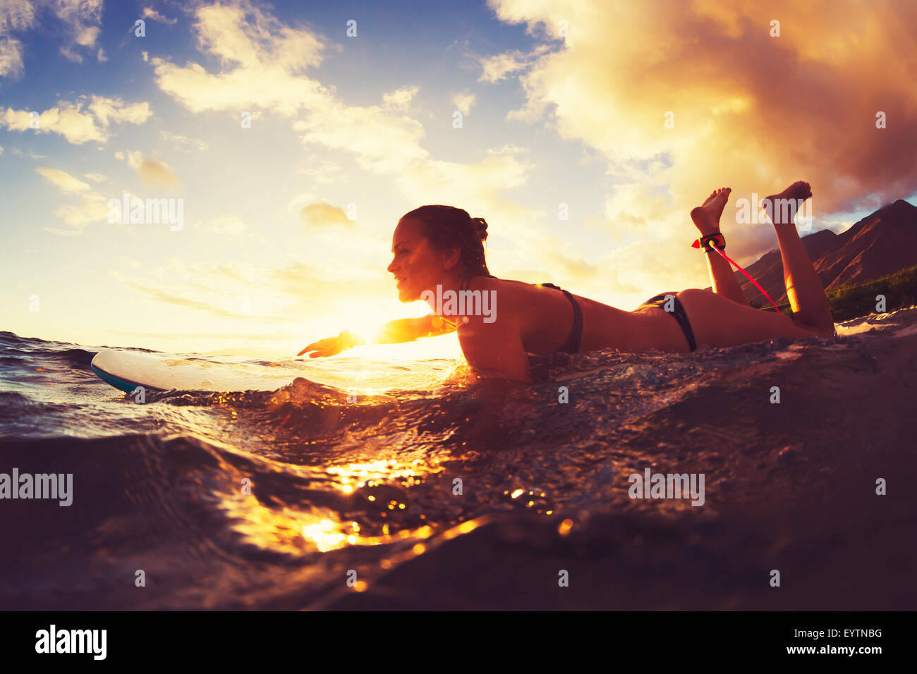 Surfing at Sunset. Outdoor Active Lifestyle. Stock Photo
