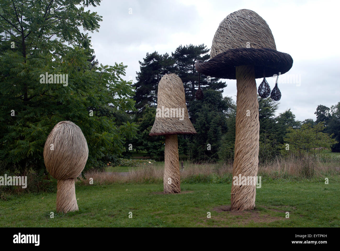 Toadstool and mushroom straw statues, West London Garden England UK Stock Photo
