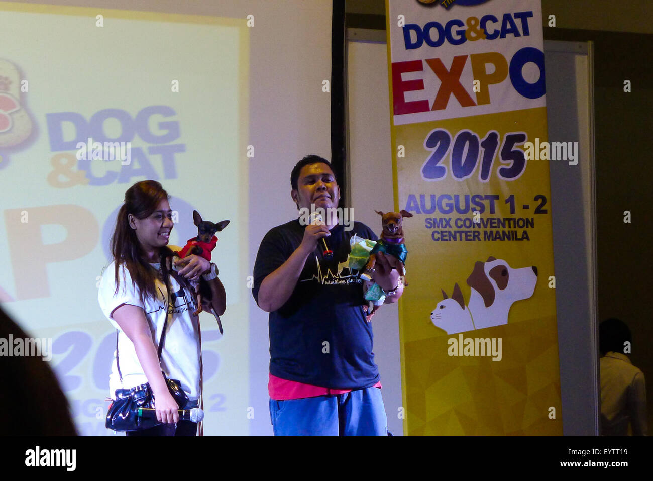 The Emcees during the trade fair giving their personal experiences about breeding of Mini Pinschers. Different breeds of dogs and cats, Dog breeders, Pet lovers unite for the same purpose, to show their care on their pets, in a unique fashion during Pet Express Dog and Cat Expo at the SMX Convention Center in Pasay City. Stock Photo
