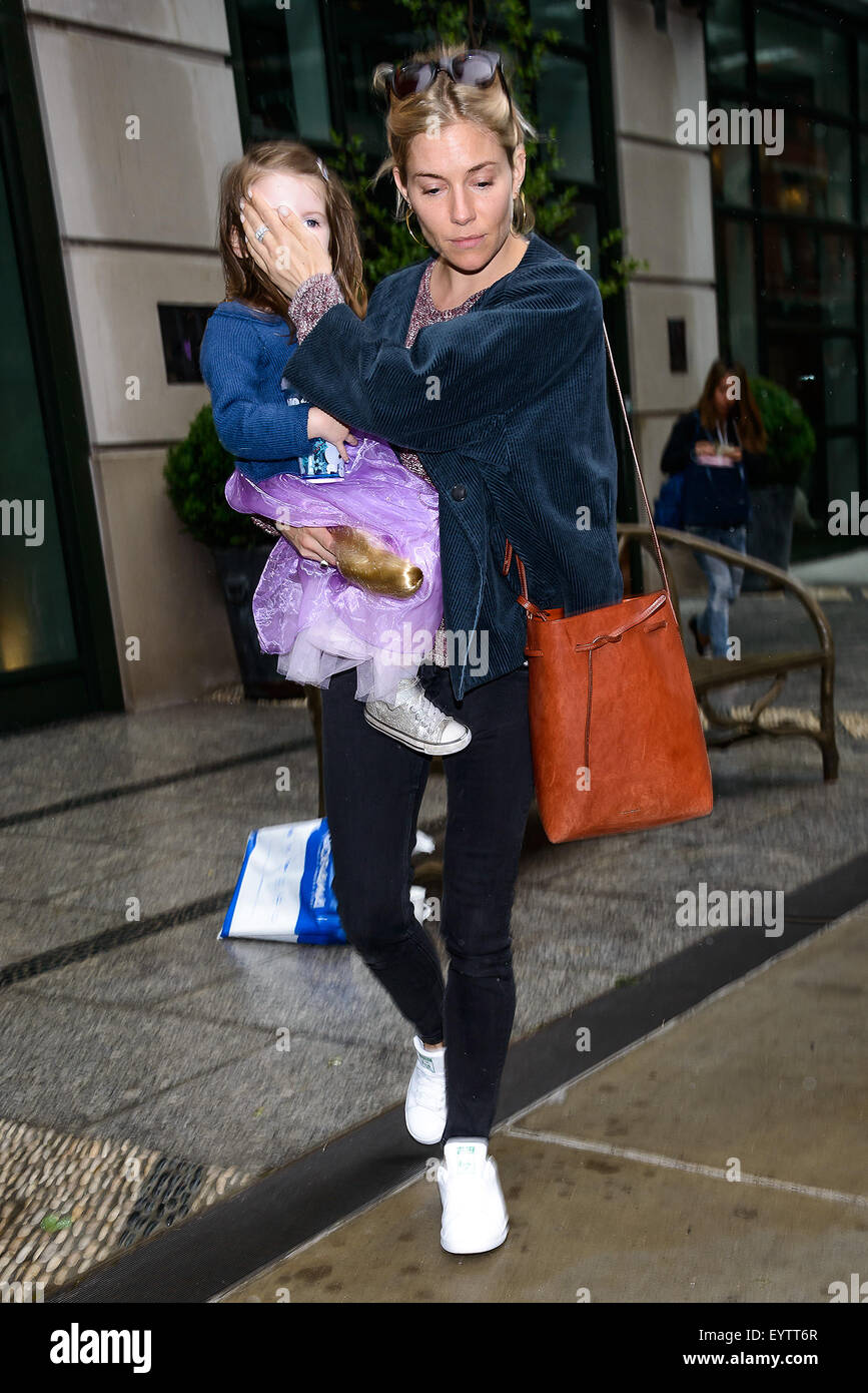 Sienna Miller carries daughter Marlowe Sturridge in her arms Featuring