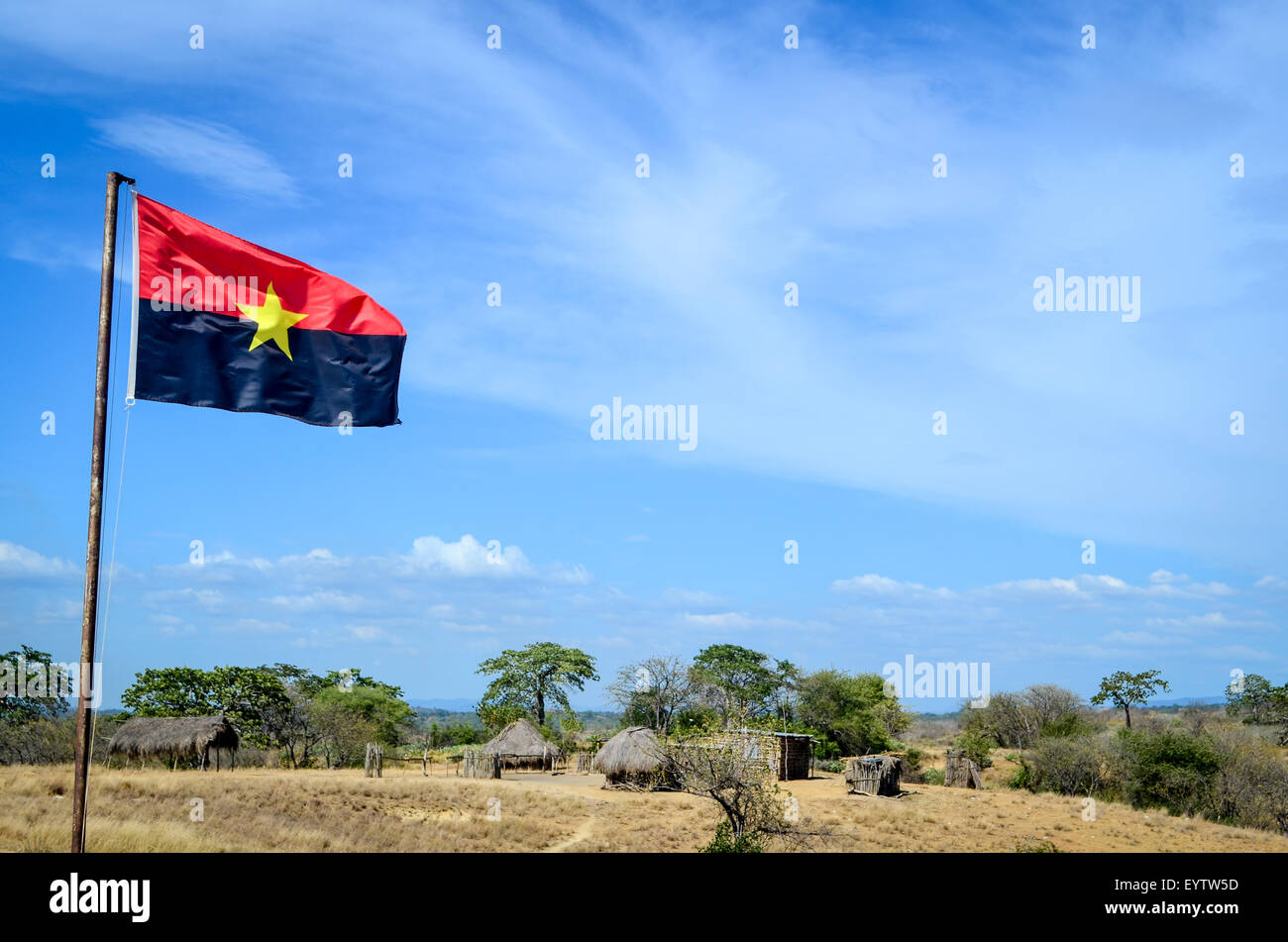 MPLA (Angolan political party) flag flying in a very rural area of Angola (no water, no electricity, no roads) Stock Photo