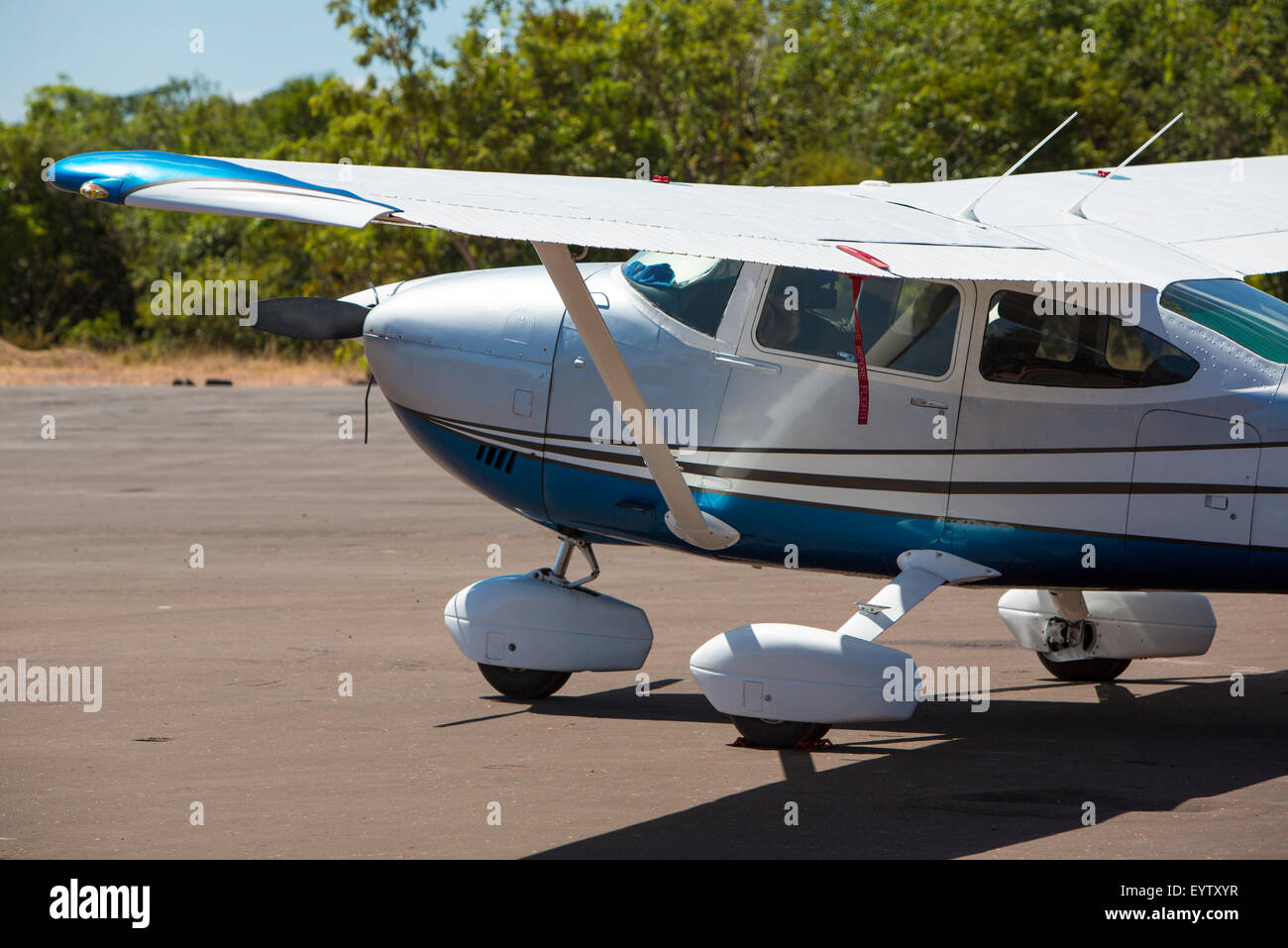 Small white airplane parked in the small airport of Canaima National Park in venezuela. The park is only accessible to small air Stock Photo