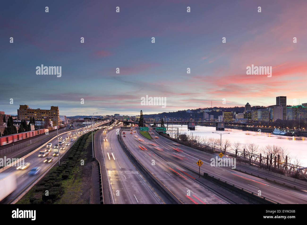 Portland Oregon rush hour traffic with city skyline along Interstate freeway during sunset evening Stock Photo