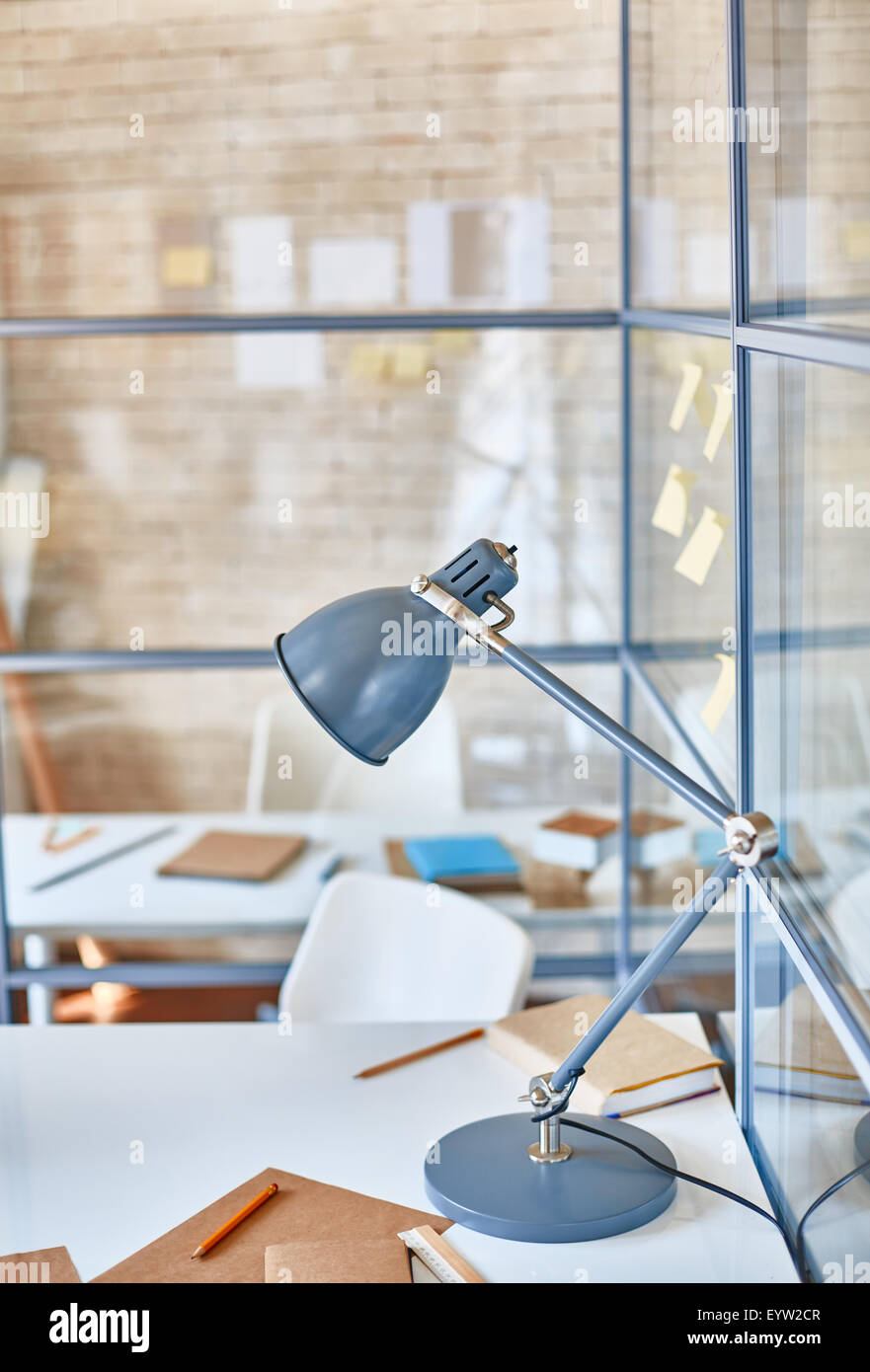 Lamp, book, notepad and pencils on desk Stock Photo - Alamy