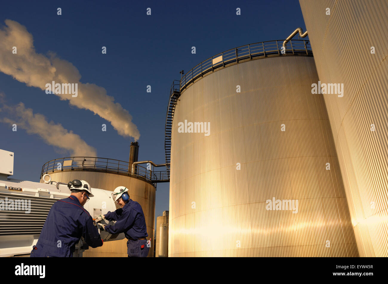 giant oil and fuel storage with workers Stock Photo