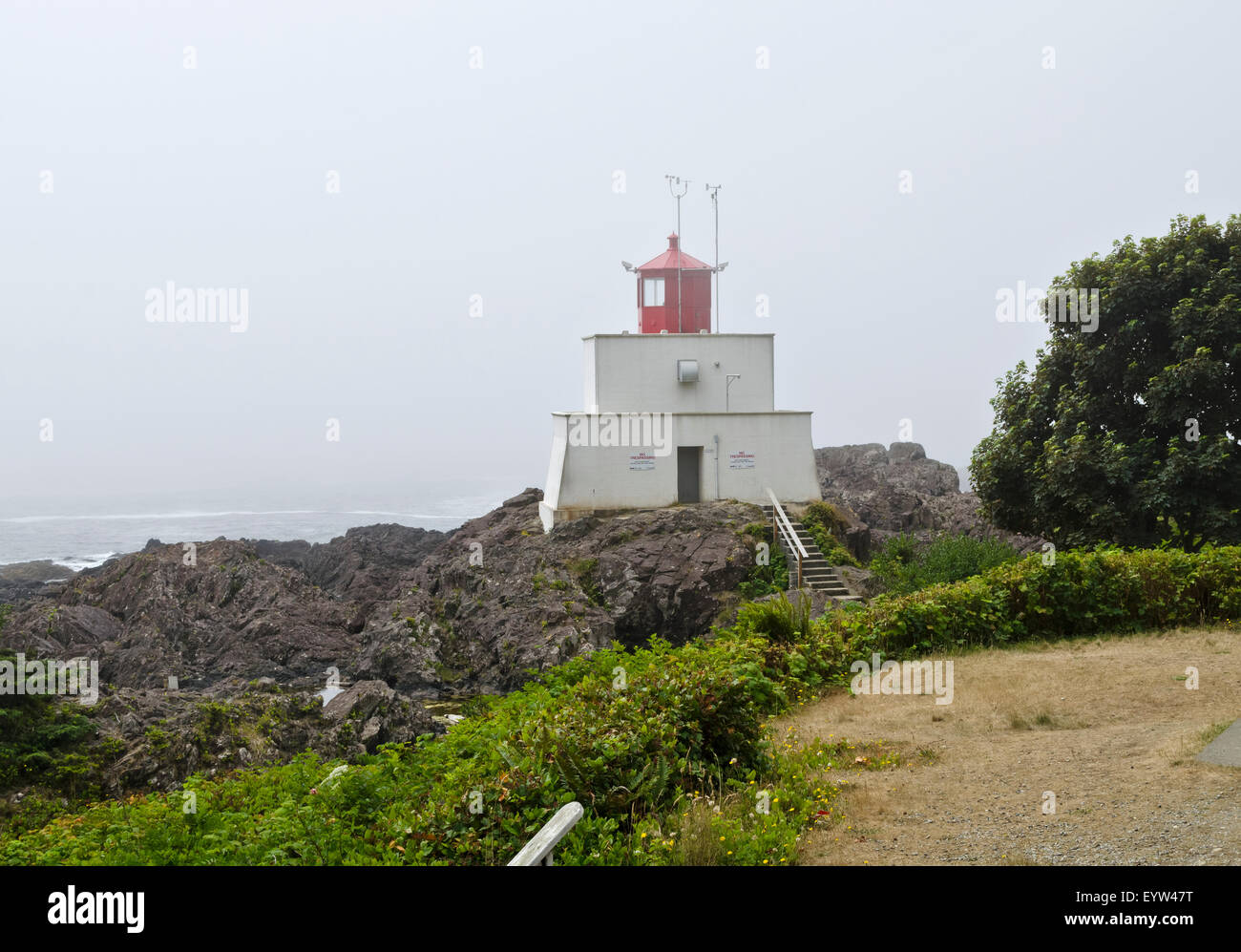 Amphitrite Point Lighthouse on a foggy day in Ucluelet, British Columbia Canada.  On the Wild Pacific Trail, Vancouver Island. Stock Photo