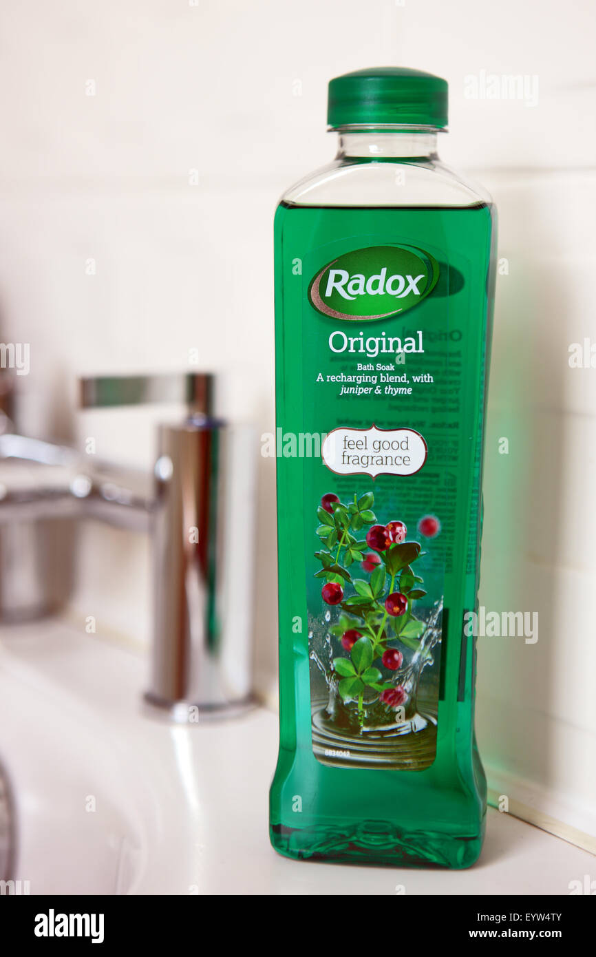 Bottle of Radox bubble bath on the edge of a bath Stock Photo