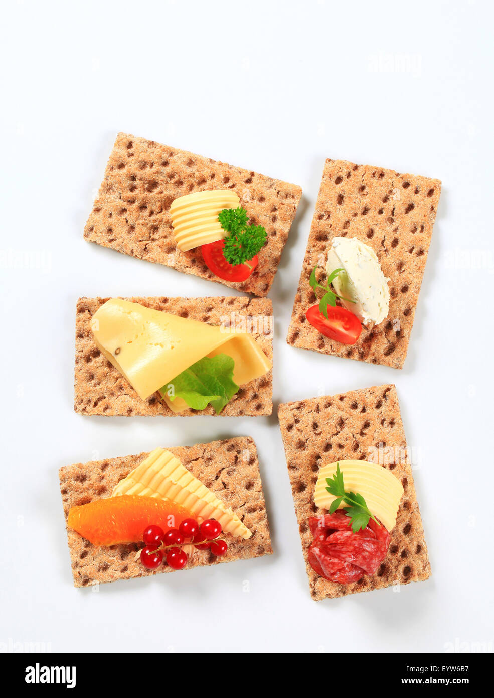 Whole grain crisp bread slices with various toppings Stock Photo