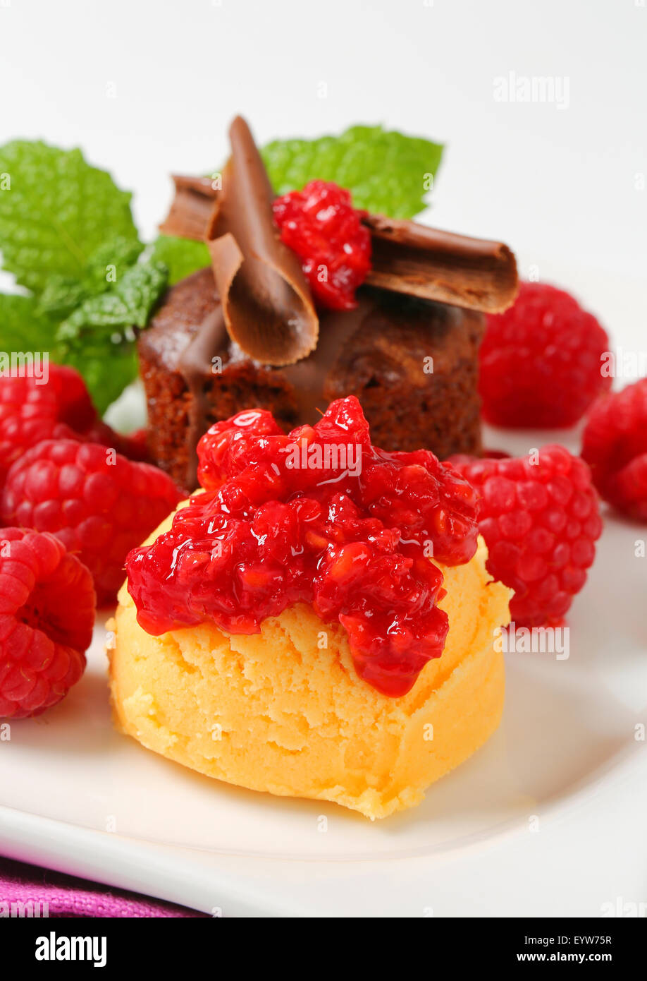 Mini chocolate cake served with fresh raspberries and scoop of ice ...