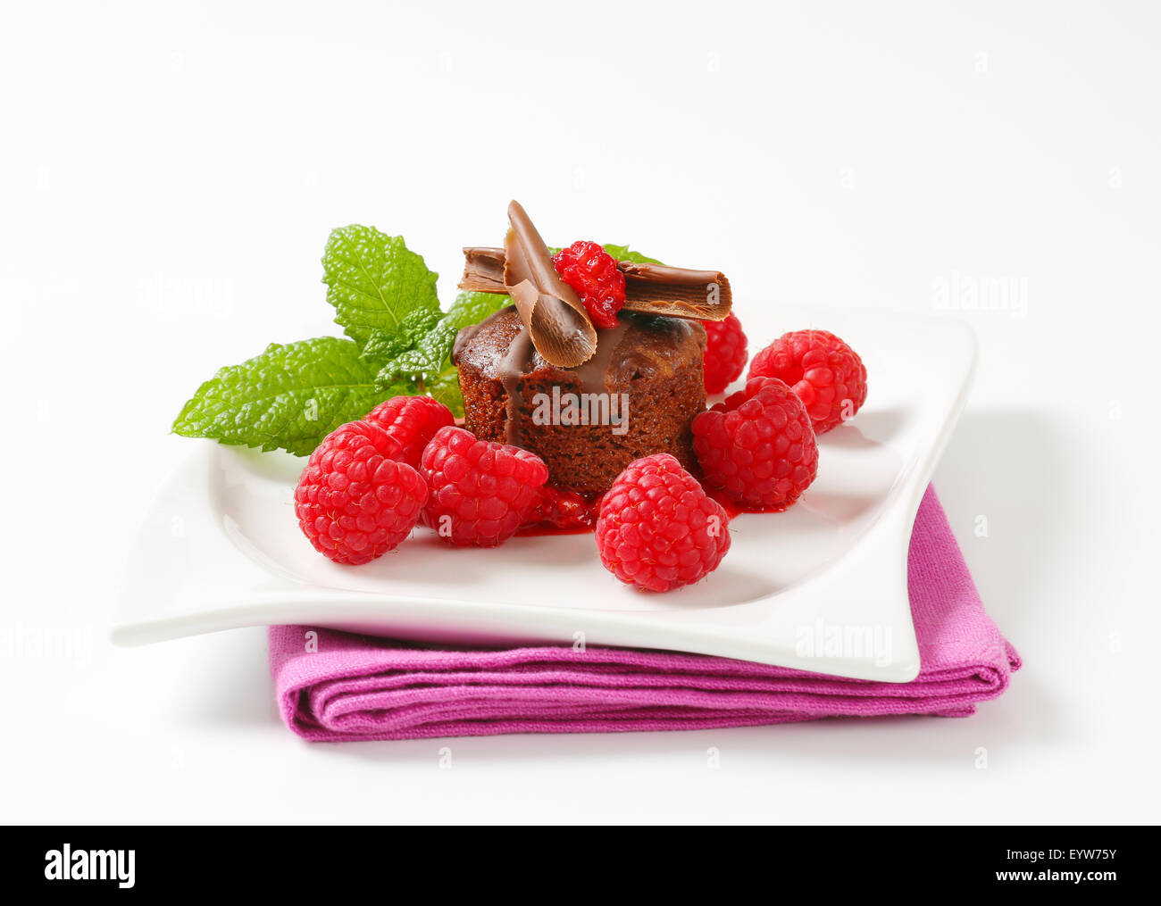 Mini chocolate cake served with fresh raspberries Stock Photo - Alamy