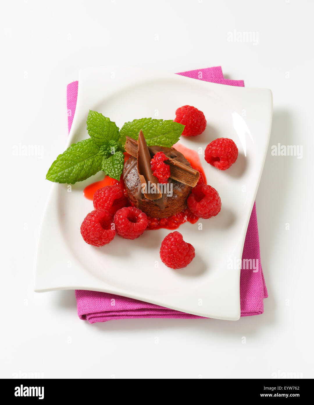 Mini chocolate cake served with fresh raspberries Stock Photo - Alamy