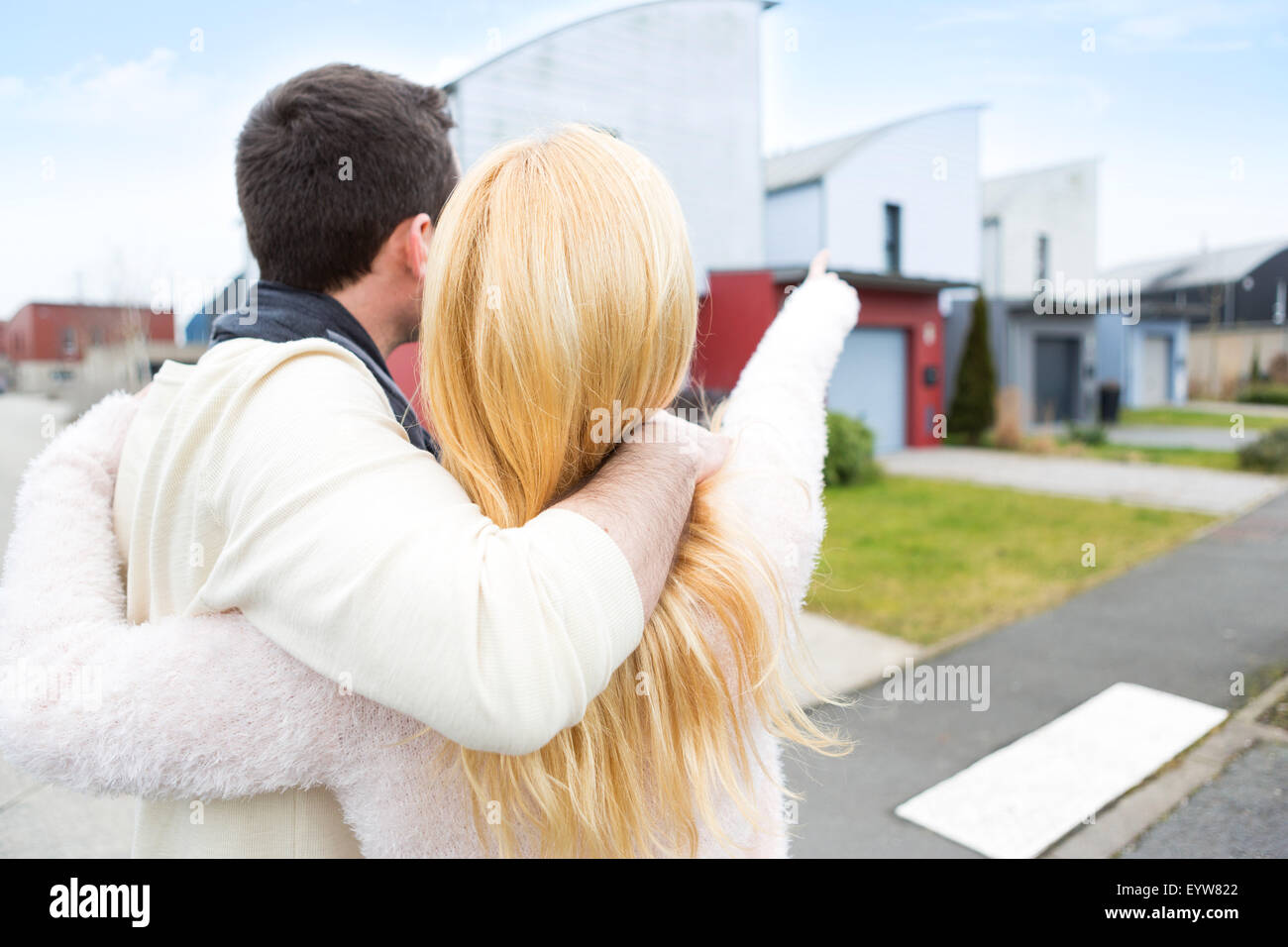 View of a Young happy couple in front of their new house Stock Photo ...