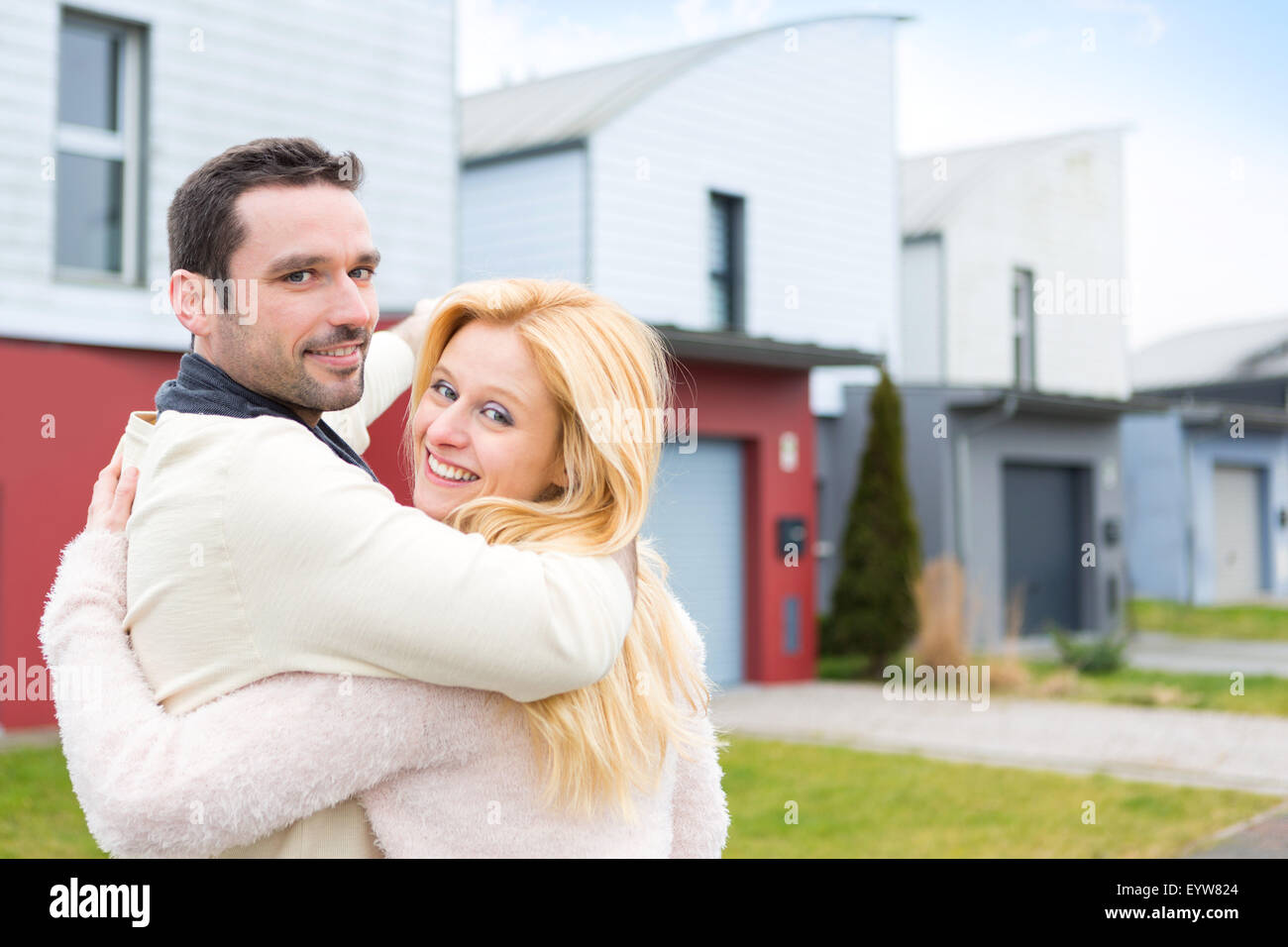 View of a Young happy couple in front of their new house Stock Photo ...