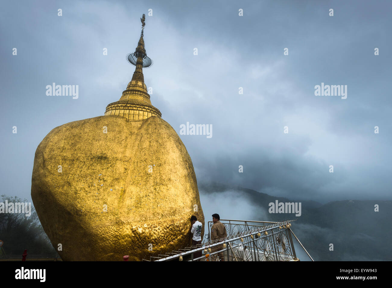 Praying believer, Golden Rock, Kyaiktiyo Pagoda, fog, Kyaikto, Thaton District, Mon State, Myanmar Stock Photo