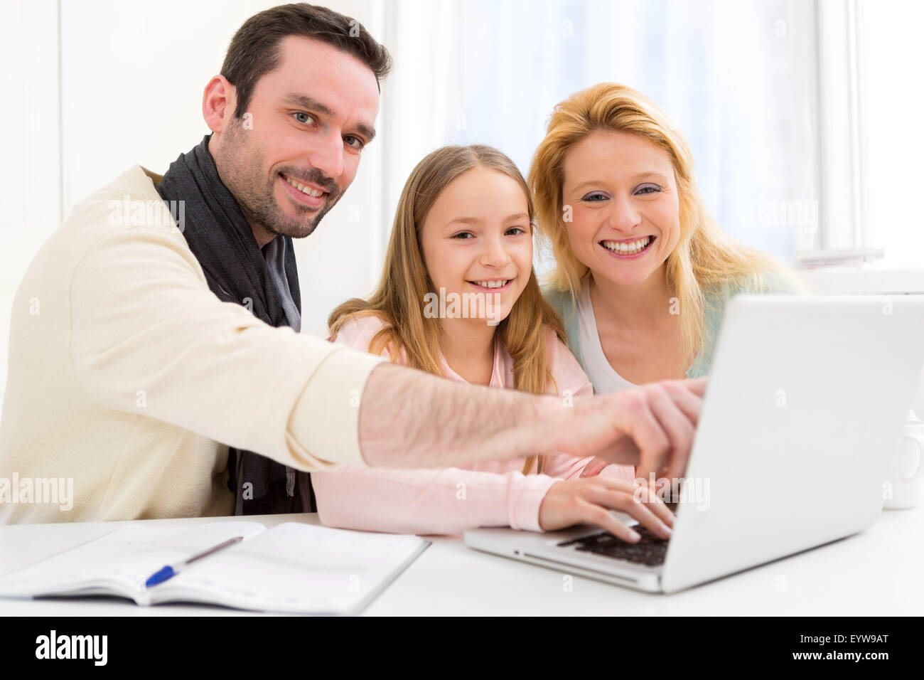 View of a Happy family in front of a laptop Stock Photo - Alamy