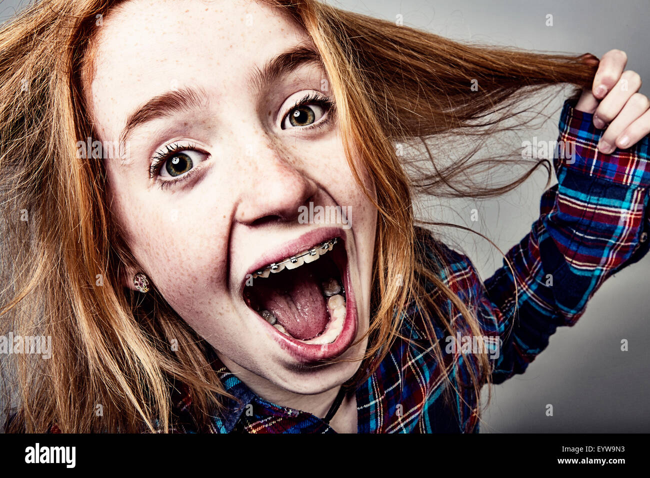 Naughty screaming red-haired girl, portrait Stock Photo