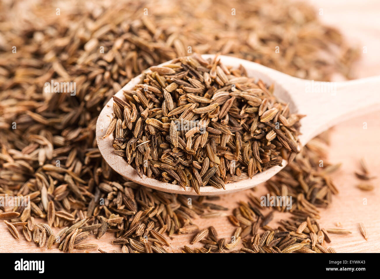 Cumin seeds in wooden spoon Stock Photo