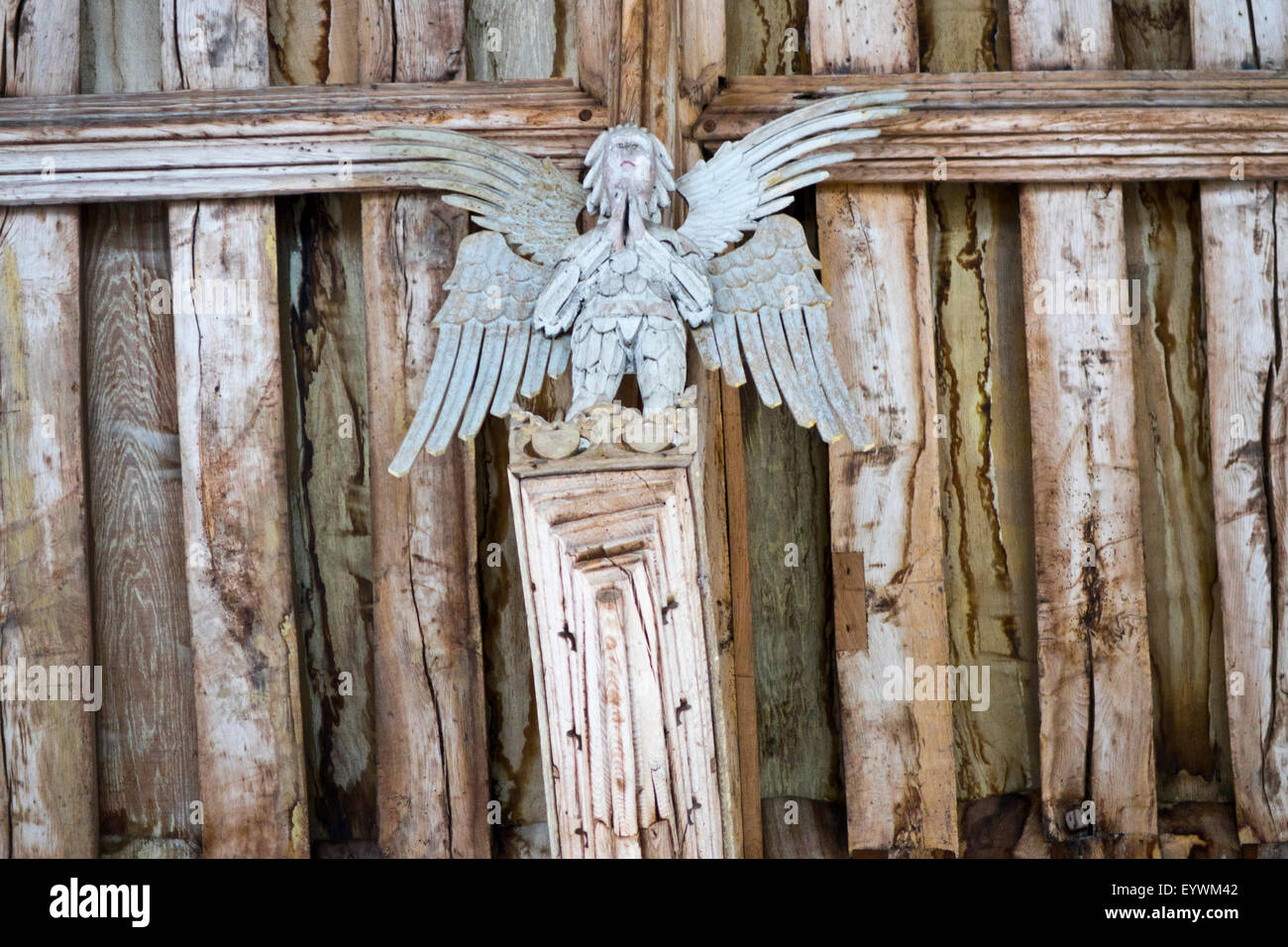 carved wooden angel on roof beam church Stock Photo