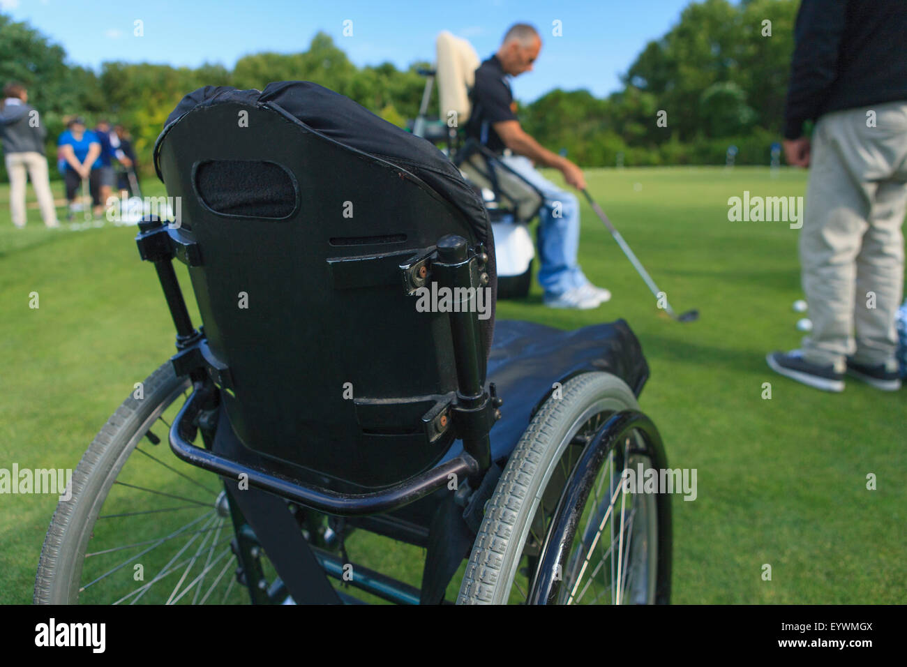 Pushing Cart Injuries Man with a spinal cord injury in an adaptive cart at golf putting green ...