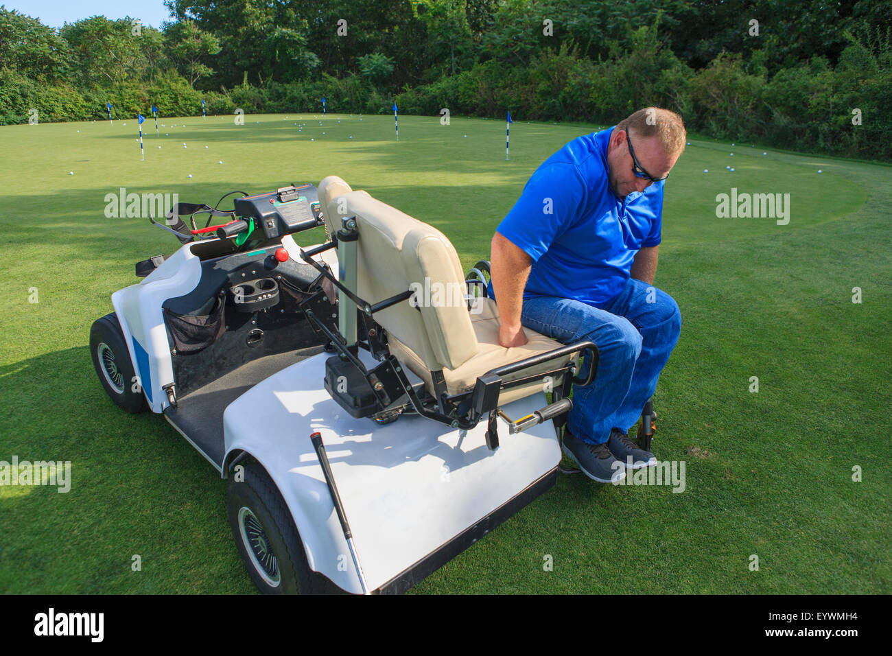 Pushing Cart Injuries Man with a spinal cord injury in an adaptive golf cart getting into his ...
