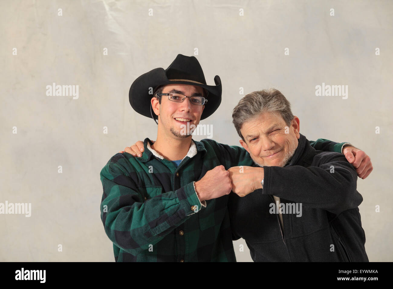 Young man with autism and his mentor smiling and knocking knuckles Stock Photo