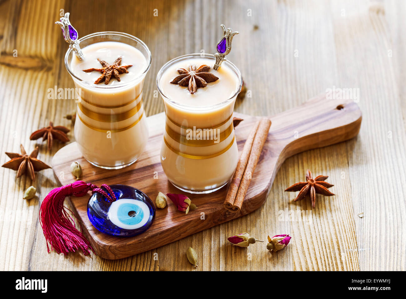 Masala tea in glass jars with spices and glass amulet Evil Eye Stock Photo