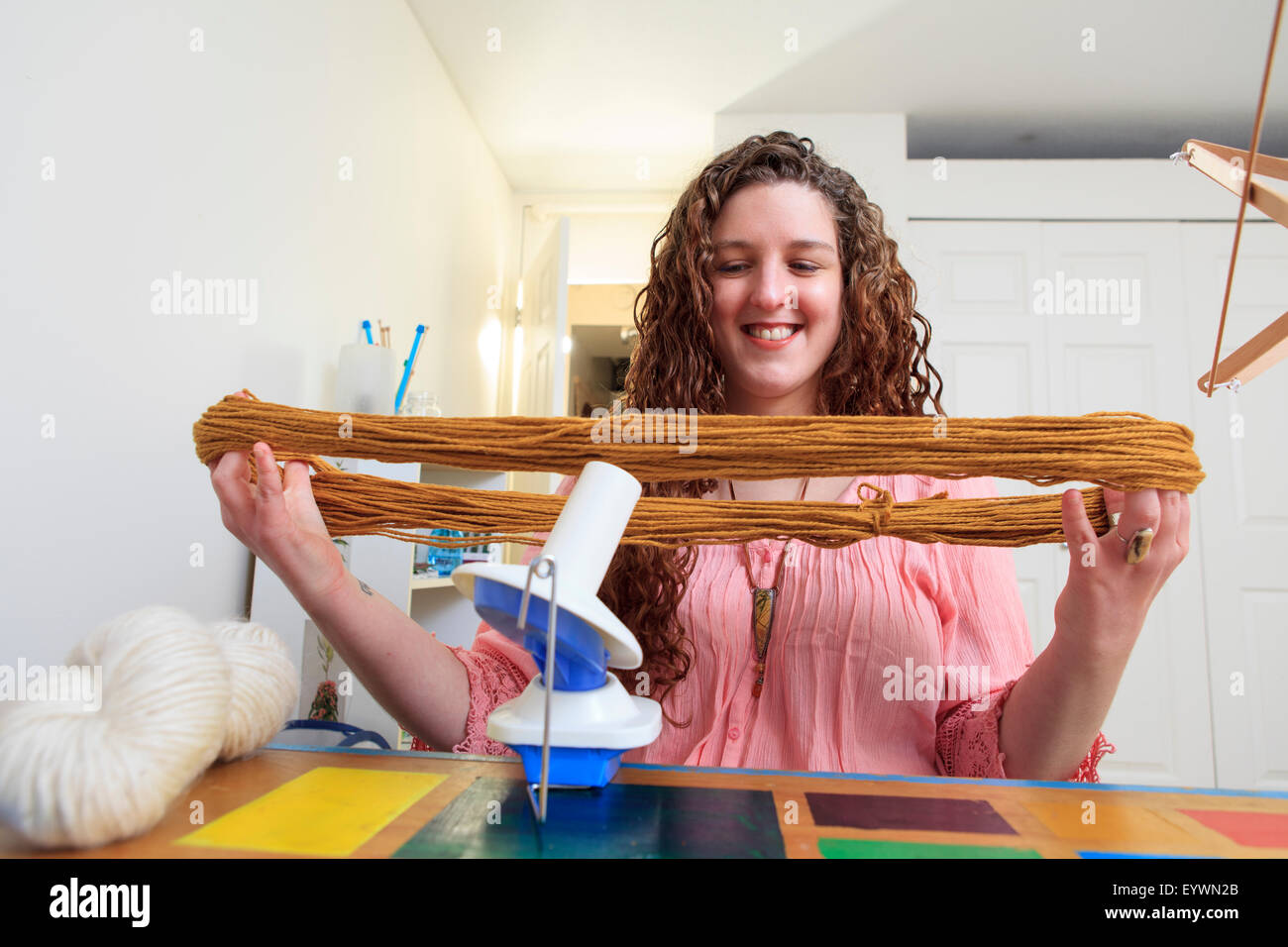 Woman with Muscular Dystrophy working with her yarn for her knitting business Stock Photo