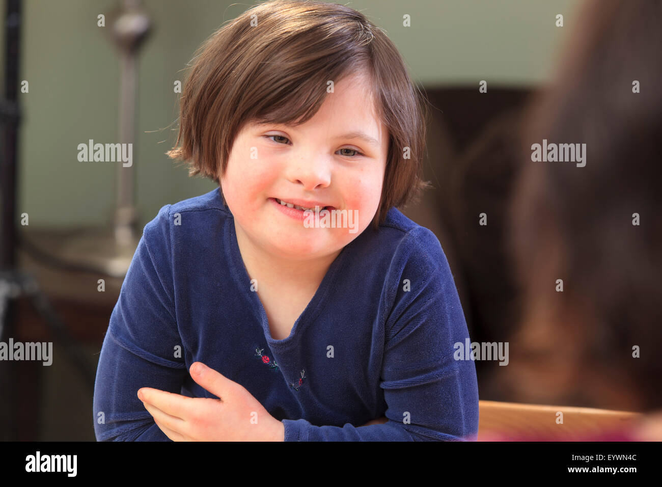 Little girl with Down Syndrome talking to her Mom Stock Photo