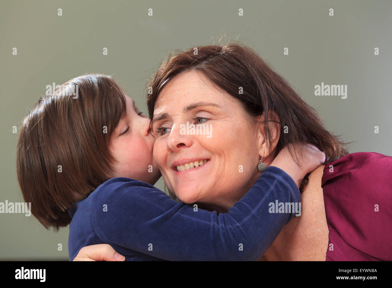 Little girl with Down Syndrome kissing her Mom Stock Photo